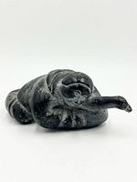 Front view of soapstone carving showing hunter and bird