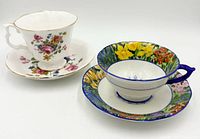Both teacup and saucer sets side by side