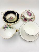 All four teacup and saucer sets displayed