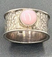 Top view showing pink opal cabochon and textured sterling silver band