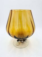 Front view of amber brandy snifter vase on clear foot