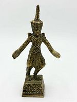 Front view of brass temple dancer showing costume, pose and base