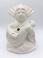 Front view of ceramic geisha planter showing instrument and glaze