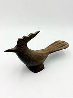 Left side view of entire ironwood roadrunner figurine showing stylized crest and tail