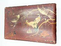 Top view showing hand-painted cranes, moon and landscape on red lacquer lid