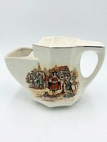 Front view showing transfer scene, handle, gold trim