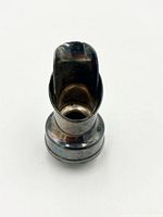 Front view of silver-plated pourer showing spout and collar