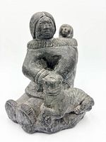 Front view of Inuit mother, child, dog sculpture