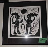 Full view of framed black and white linocut print showing design and frame
