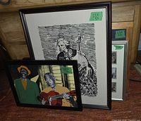 Three framed artworks including B&W woodcut musician print and color jazz collage