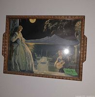 Front view of wood framed serving tray with romantic moonlit print and side handles