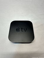 Top view of Apple TV showing logo and surface scratches
