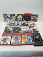 All 17 PS3 game cases and disc displayed on tabletop