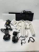 Overview showing keyboards, power strips, adapters, chargers and cables