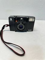 Front view of Minolta Talker camera with wrist strap attached