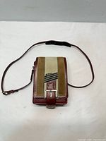 Front view showing Nikon logo, leather and suede panels, buckle