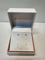 Earrings displayed inside open Primrose box