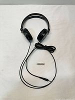 Full view of headphones and adapter laid flat