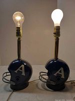 Front view of both helmet lamps with bulbs installed showing overall form and team decals