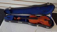 Violin resting inside open hard case