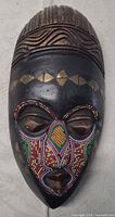 Full view of carved wooden wall mask