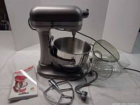 Mixer with bowl, shield, attachments, booklet
