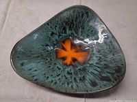 Top view showing teal/turquoise glaze with orange center