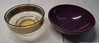 Side-by-side view of glass bowl and purple ceramic bowl