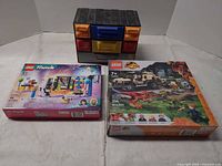 Lot overview showing both LEGO set boxes and storage organizer