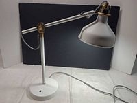 3/4 view of entire lamp showing base, arm, shade and cord