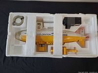 Submarine in styrofoam tray with remote and ring visible
