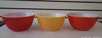 Side view of three Pyrex bowls showing exterior colors and condition