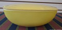 side view of yellow Pyrex casserole with lid attached