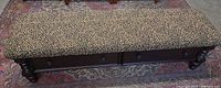 Full view of bench showing leopard upholstered seat and wood base