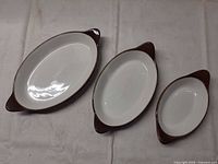 Top view of the three oval brown-and-white stoneware dishes
