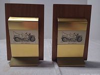 Front view of both wood and metal bookends with 1907 Cadillac illustration