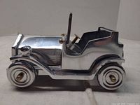 right side view showing chrome body, brass accents, rolling wheels