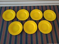 Seven yellow plates top view