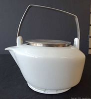 side view showing body, spout, handle, lid