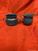 Front view of both blue speckled enamel pieces showing form and color