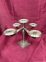 Front angled view showing five candle cups, brushed nickel finish, square base