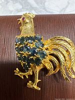 Front view showing sapphire-set body and ruby eye