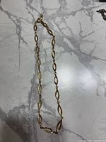 Full view of necklace showing link pattern and clasp