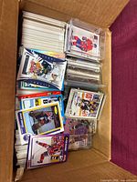 Open box showing stacks of hockey trading cards, loose and in protective holders