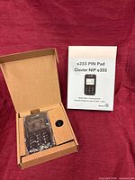 Moneris e355 PIN pad sealed in plastic inside original box with instruction leaflet displayed
