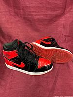 Side and sole view of both sneakers showing colorway, design and tread wear