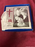 Frame inside box showing cross/bible design and 4x6 size marking