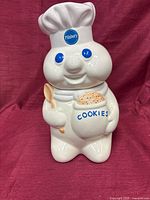 Front view of Pillsbury Doughboy ceramic cookie jar with lid in place