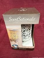 Front of boxed ScentSationals Maebly plug-in wax warmer