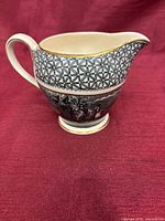Side view of porcelain creamer showing pattern and shape